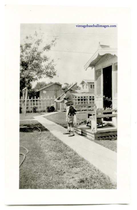 Vintage snapshot of boy posing in his batting stance with glove on hip, circa 1920s/'30s