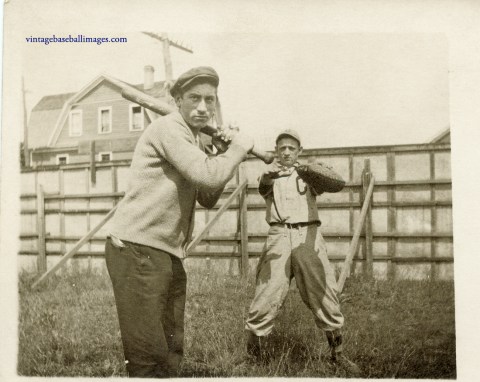 amateur baseball players pose as if hitting and catching in circa 1920s snapshot